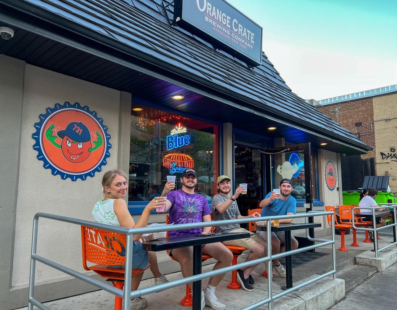 Friends enjoying drinks on the Orange Crate patio